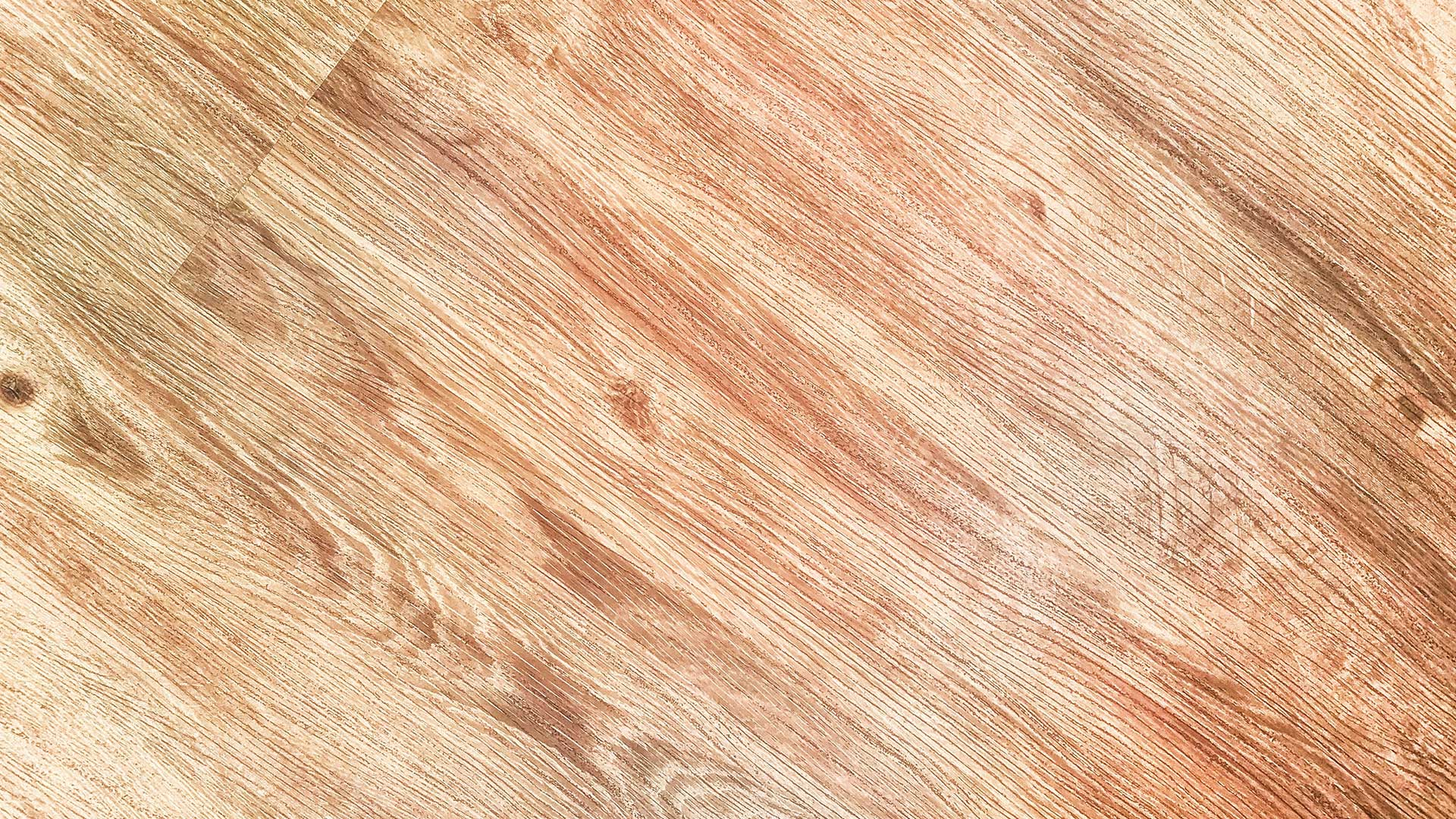 top-down diagonal view of smooth light-colored wood grain texture