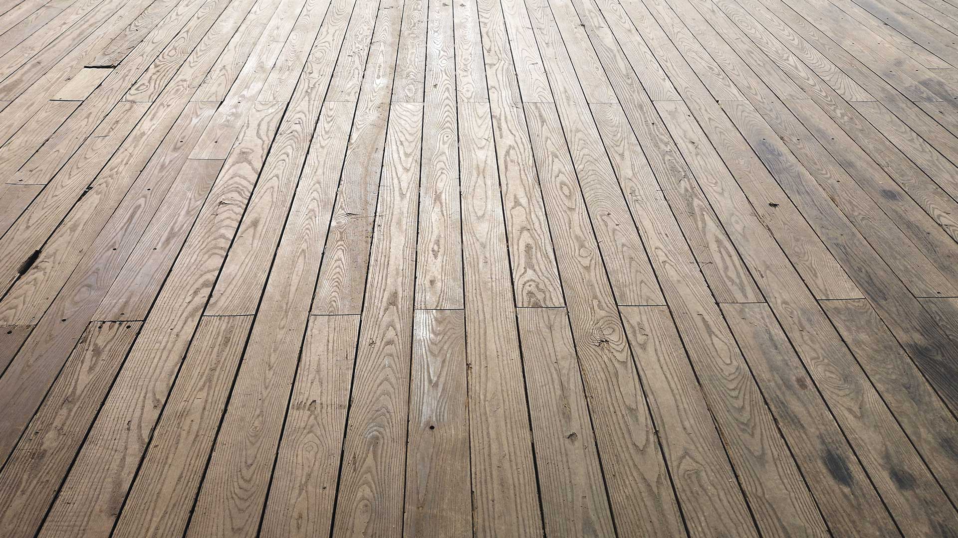 overhead close-up view of weathered vertical wooden deck planks